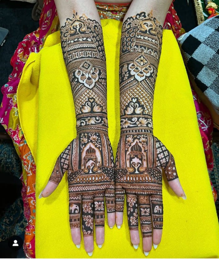 Peacock and jaali bridal mehndi on yellow backdrop
