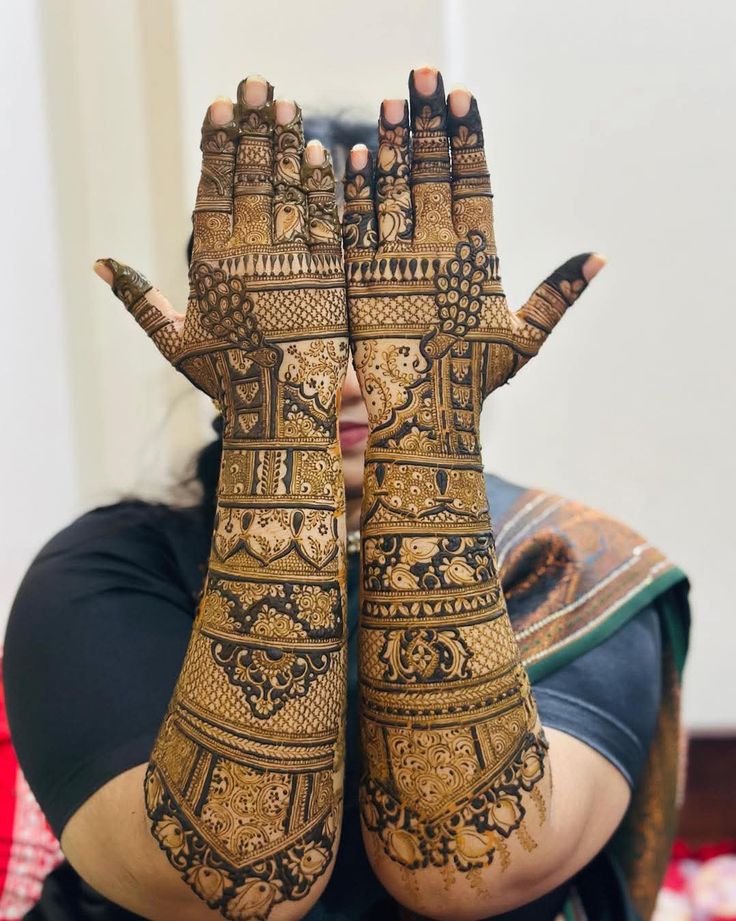 Fine-line bridal mehndi covering both arms