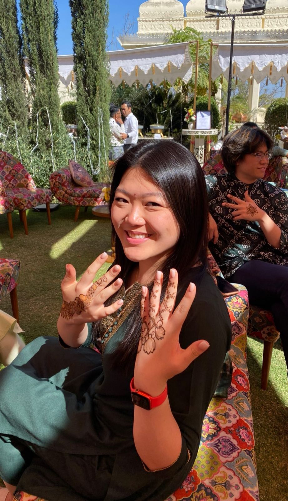Happy client with floral henna design on both hands
