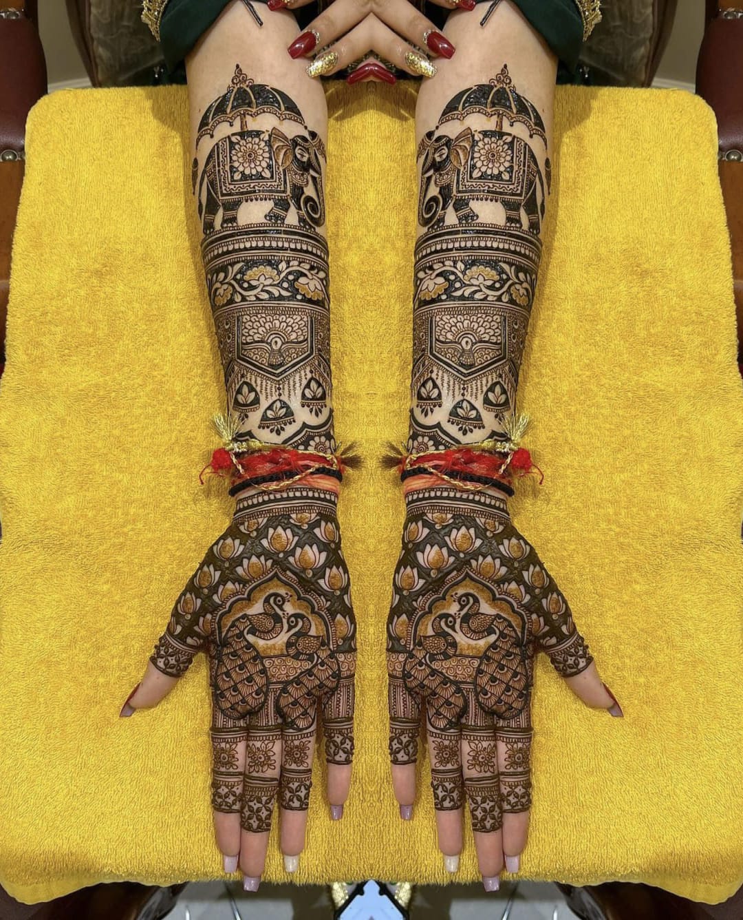 Peacock and lotus bridal mehndi on hands and arms