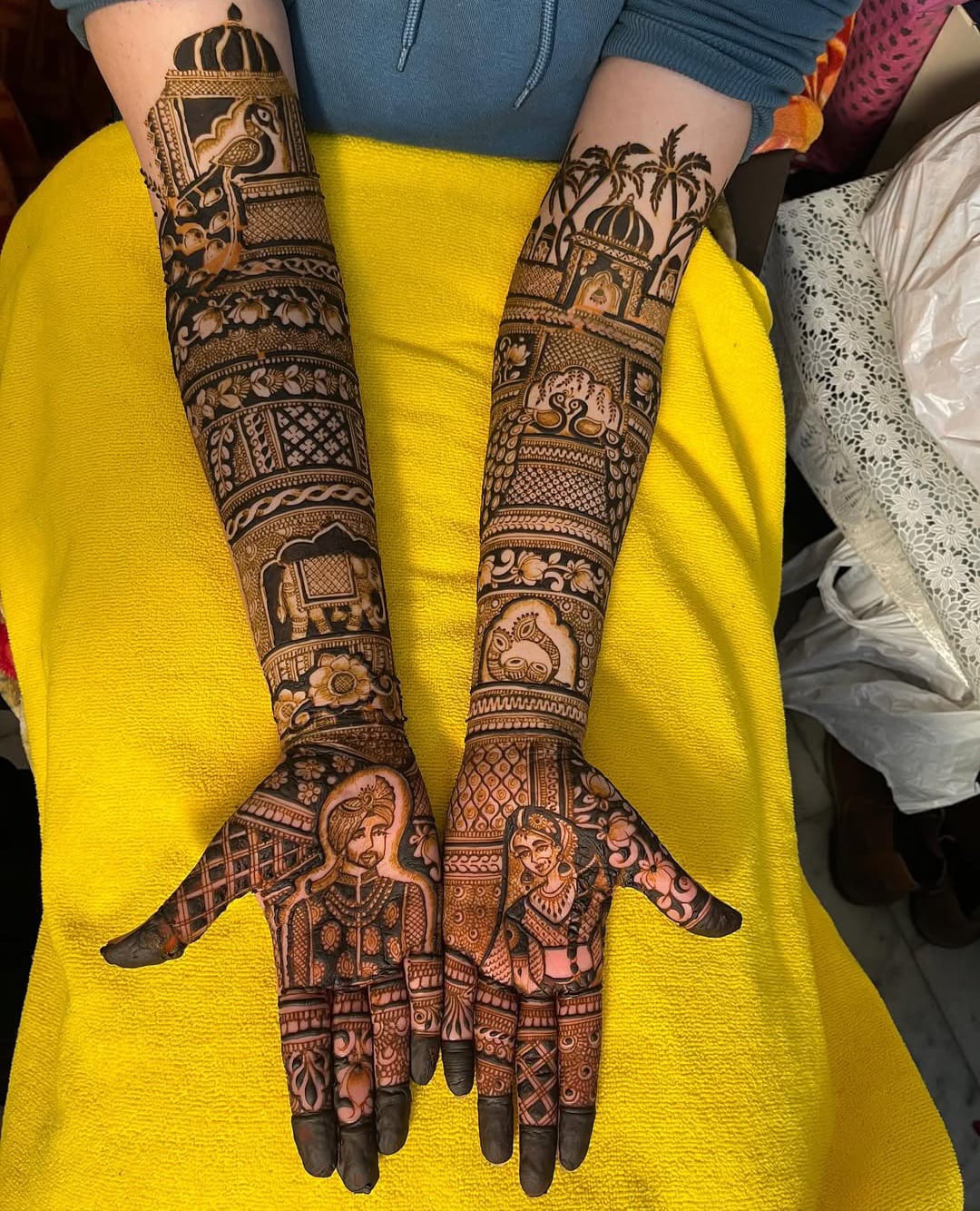 Rajasthani bridal mehndi with palm trees and royal portraits