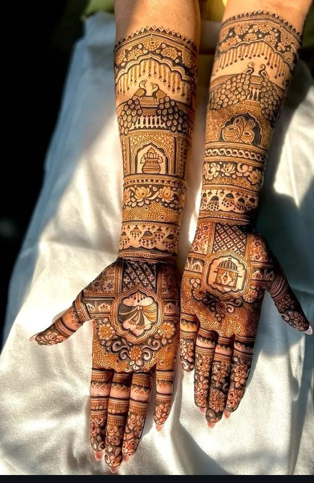 Sunlit bridal mehndi with temple and peacock motifs