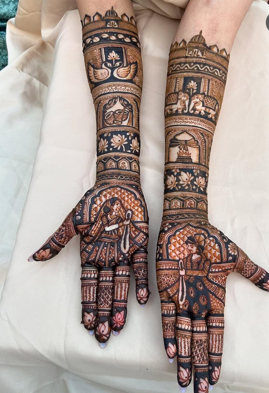 Intricate bridal mehndi with lotus, elephants and bride-groom art